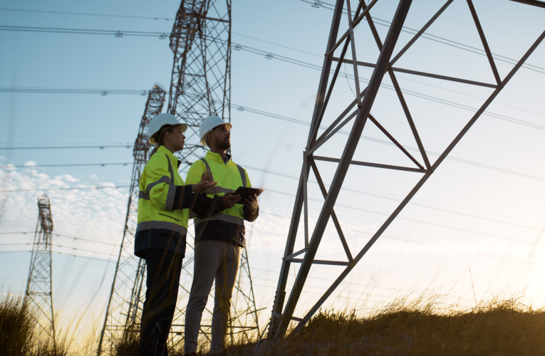 Teamwork, electrical engineer and inspection in power station with people for electricity transmission and tower check. Engineering, back and collaboration for energy distribution or mockup in field